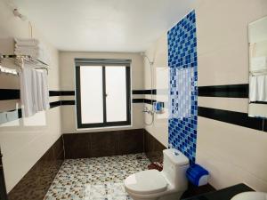 a bathroom with a toilet and a window at Trang An Peaceful Homestay in Ninh Binh