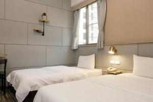 Letto o letti in una camera di At Tainan Inn