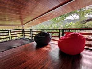a large red bean bag chair sitting on a deck at Cabaña Hamacas in Cartago