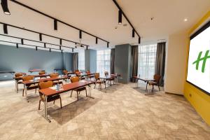 a classroom with tables and chairs and a projection screen at Holiday Inn Bucharest - Times by IHG in Bucharest +89 photos