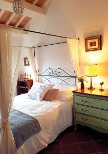 a bedroom with a canopy bed and a dresser at SelvaGiurata Farmhouse Villa in San Benedetto del Tronto +33 photos