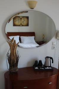 a mirror on top of a dresser in a bedroom at Sofotel in Koroni