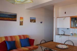 a living room with a couch and a table at CasaLella in Letojanni +19 photos