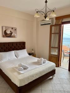 a bedroom with a bed with two towels on it at Sofotel in Koroni