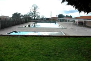 a large swimming pool in a yard next to a house at HOTEL CRUZ DA MATA in Mangualde