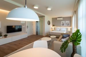 a living room with a bed and a couch at Hotel Rural Tierras del Cid in Quintanadueñas