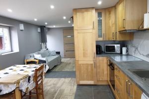 a kitchen and living room with a bed and a table at Jolie maison de centre-ville: Le Tournesac in Héricourt