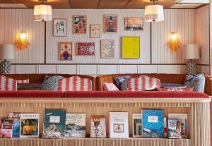 a restaurant with a counter with books on it at Hotel de Silhouette in Biarritz