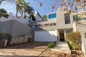 a large white house with a white garage at LA ARMONIA in Córdoba