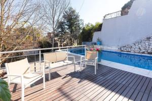 a deck with two chairs and a table at LA ARMONIA in Córdoba