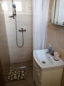a bathroom with a sink and a shower at Ubytovňa Ivona in Hroboňovo
