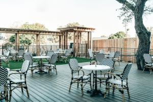 a bunch of tables and chairs on a deck at Colton House Hotel in Austin