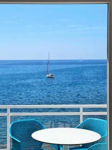 a boat in the ocean with a table and chairs at Acapulco Ocean View in San Agustin