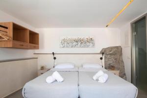 ピュロスにあるNestor's studio houseの白い枕2つが備わる客室内のベッド2台