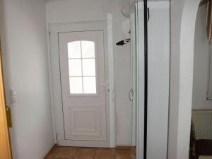 a white door with a window in a room at Detached holiday home with fenced garden in Schmiedefeld am Rennsteig
