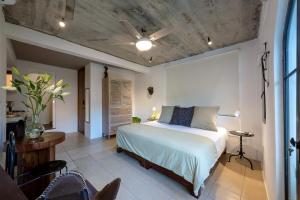 a bedroom with a bed and a ceiling fan at Casa Lucas in Puerto Vallarta