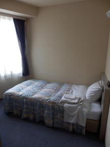 Säng eller sängar i ett rum på Hotel Hinodeya