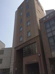 a building with a sign on the front of it at Hotel Hinodeya in Kanazawa