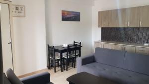 a living room with a blue couch and a table at Arteg Apartments - Delux in Durrës