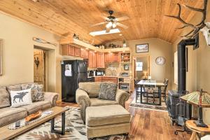 a living room with two couches and a kitchen at Red Lodge Retreat with Hot Tub 3 Blocks to Downtown in Red Lodge