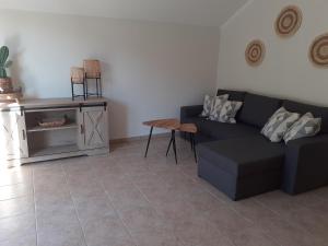 a living room with a couch and a table at VILLA ZRMANJA - 3 appartementen in Obrovac