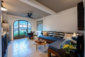a living room with a blue couch and a table at Casa Lucas in Puerto Vallarta