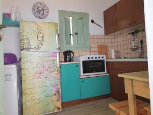 a kitchen with a blue refrigerator and a microwave at Amazing View in Kokkala