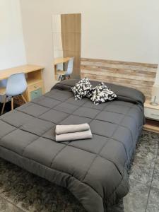 a large bed with two towels on top of it at Apartamento Can Jasana in Sant Jordi de Cercs