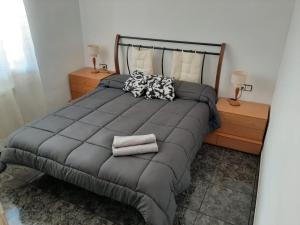 a bedroom with a large bed with two night stands at Apartamento Can Jasana in Sant Jordi de Cercs +6 photos