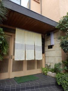 a front door of a house with a curtain on it at Kikunoya Ryokan in Kanazawa