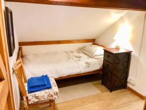 a small bedroom with a bed and a night stand at Hillfort in Ruthin