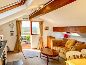 a living room with a couch and a table at Heather in Ruthin