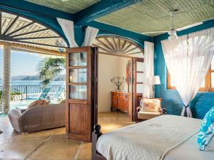a bedroom with a bed and a view of the ocean at Villa Amor in Sayulita +169 photos