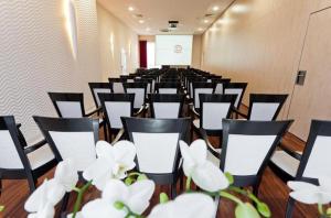 a row of chairs in a room with white flowers at Restauracja 32 Motel in Gryfice