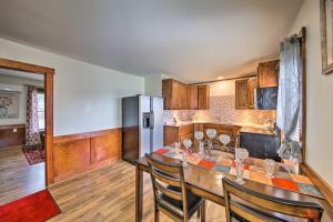 a kitchen with a table with chairs and a refrigerator at Cozy Ellsworth Home with Yard, 15 Mi to Acadia! in Ellsworth