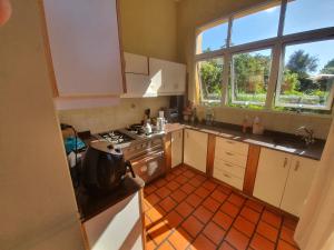 a small kitchen with a stove and a window at Casa Astoria in San Pedro