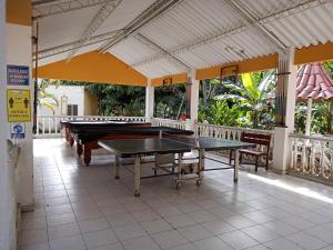 two ping pong tables sitting inside of a building at Hotel Villa San Cayetano in Nocaima