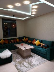 a living room with a couch and a coffee table at Adrarhost in Agadir