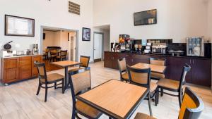 un restaurante con mesas, sillas y una barra en SureStay Plus Hotel by Best Western Hammond, en Hammond