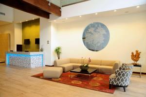 a living room with a couch and a table and chairs at Best Western Plus Panama Zen Hotel in Panama City