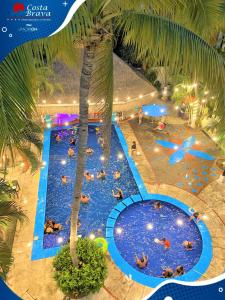 an overhead view of a large swimming pool with people in it at Hotel Costa Brava in Manzanillo