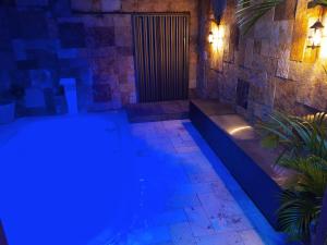 a swimming pool lit up at night with lights at Casa Recanto do sol in Natal