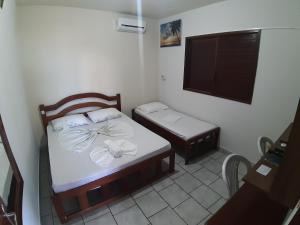 Una cama o camas en una habitación de Pousada Mirante do Pontal