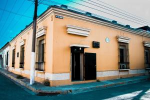 an orange building on the side of a street at Hostal Sole in Santa Ana