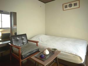 Ένα ή περισσότερα κρεβάτια σε δωμάτιο στο Takeyaso Ryokan