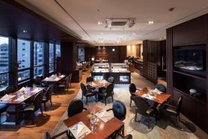 a restaurant with wooden tables and chairs and a counter at Oakwood Premier Coex Center in Seoul