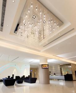 a large chandelier hangs from the ceiling of a hotel lobby at Forte Hotel Changhua in Changhua City