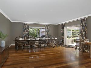 a dining room with a table and chairs at Hillview Cottage in Bowral