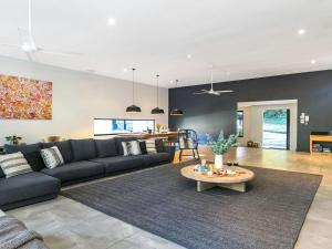 a living room with a couch and a table at The Gullies Retreat in Bundanoon