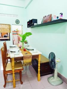 a dining room with a table and a fan at The whole house not share for 5 guests in Hat Yai